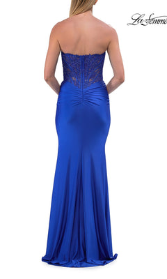 A woman is shown from the back wearing the La Femme 33509 Strapless Long Mermaid Prom Dress, a floor-length royal blue gown featuring a beaded-lace corset bodice and a fitted satin skirt.