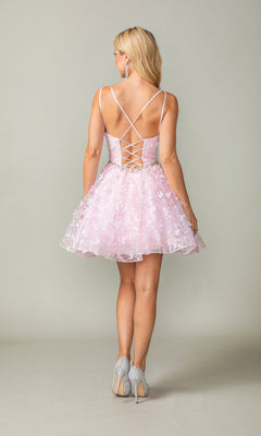 A woman with blonde hair faces away, wearing the Three-D Short Butterfly Homecoming Dress 3350 in light pink, featuring a lace-up back and corset-style bodice, paired with light-colored high heels.