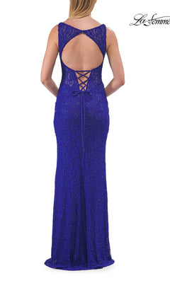 A woman is shown from behind wearing the Long Prom Dress: La Femme 33519—a sleeveless, floor-length royal blue gown featuring an open back, lace-up detail, and textured fabric. This elegant design perfectly embodies the allure of a lace prom dress.