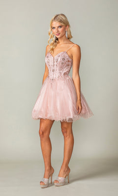 A woman wears the Sheer-Corset Short Babydoll Hoco Dress 3351—light pink, sleeveless, with lace-up detail, tulle, and floral accents—paired with high heels, posing against a plain background.