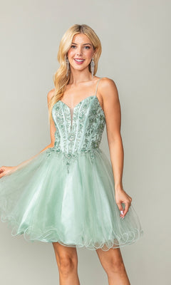 Wearing the Sheer-Corset Short Babydoll Hoco Dress 3351—a light green, sleeveless, semi-formal dress with floral embroidery and a tulle skirt—a woman stands against a plain background, smiling as she holds the side of her dress.