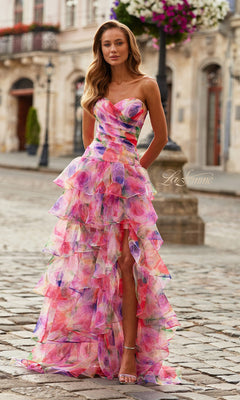 A woman stands on a cobblestone street in the La Femme 33555 Long Prom Dress, featuring a strapless sweetheart neckline, multicolored tiers, and a high slit. She pairs the multi-hued gown with strappy heels amid historic buildings.