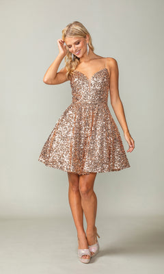 A woman stands smiling against a plain background, wearing the Short Sequin A-Line Homecoming Dress 3356—a sparkly gold dress with thin straps and a sweetheart neckline.