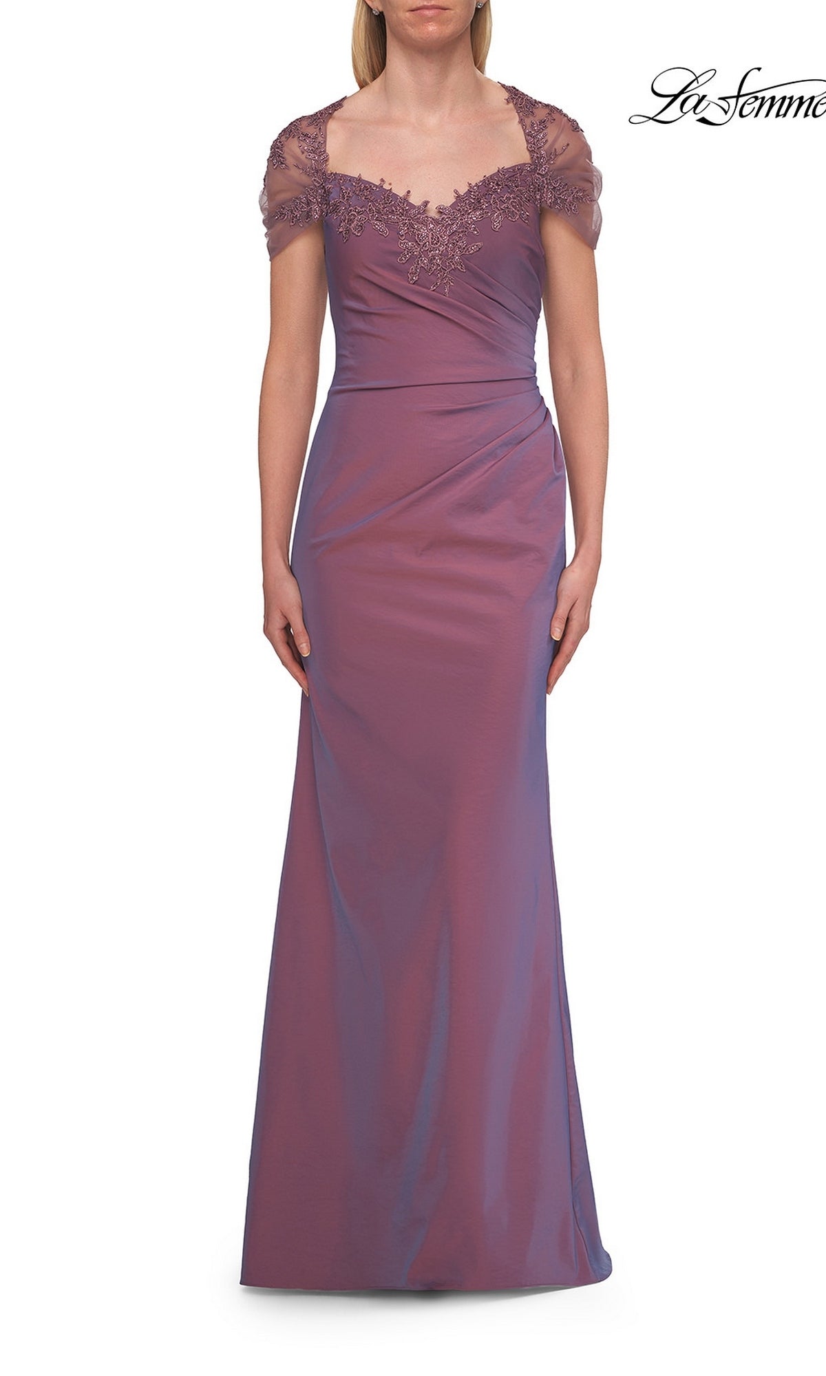 Woman wearing a floor-length, orchid La Femme 33579 back cut-out long formal dress with a lace-trimmed neckline and sheer cap sleeves, standing against a white background—an elegant choice for a mother of the bride dress.