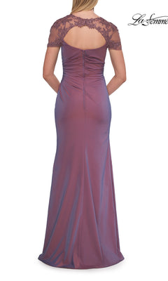 A woman stands with her hands clasped behind her in the La Femme 33579 Back Cut-Out Long Formal Dress—a floor-length, mauve gown featuring short lace sleeves and a keyhole back, making it a graceful choice for a mother of the bride.