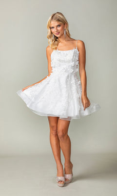 A woman models the Embellished Short Babydoll Homecoming Dress 3357, featuring 3-D floral details and spaghetti straps, as she stands against a plain background holding out her skirt.