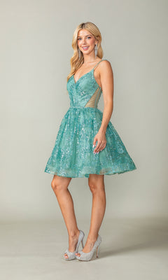 A woman stands in a studio wearing the Short A-Line Glitter-Print Homecoming Dress 3360, a sleeveless teal semi-formal dress with sequins, sheer side panels, and silver high heels.