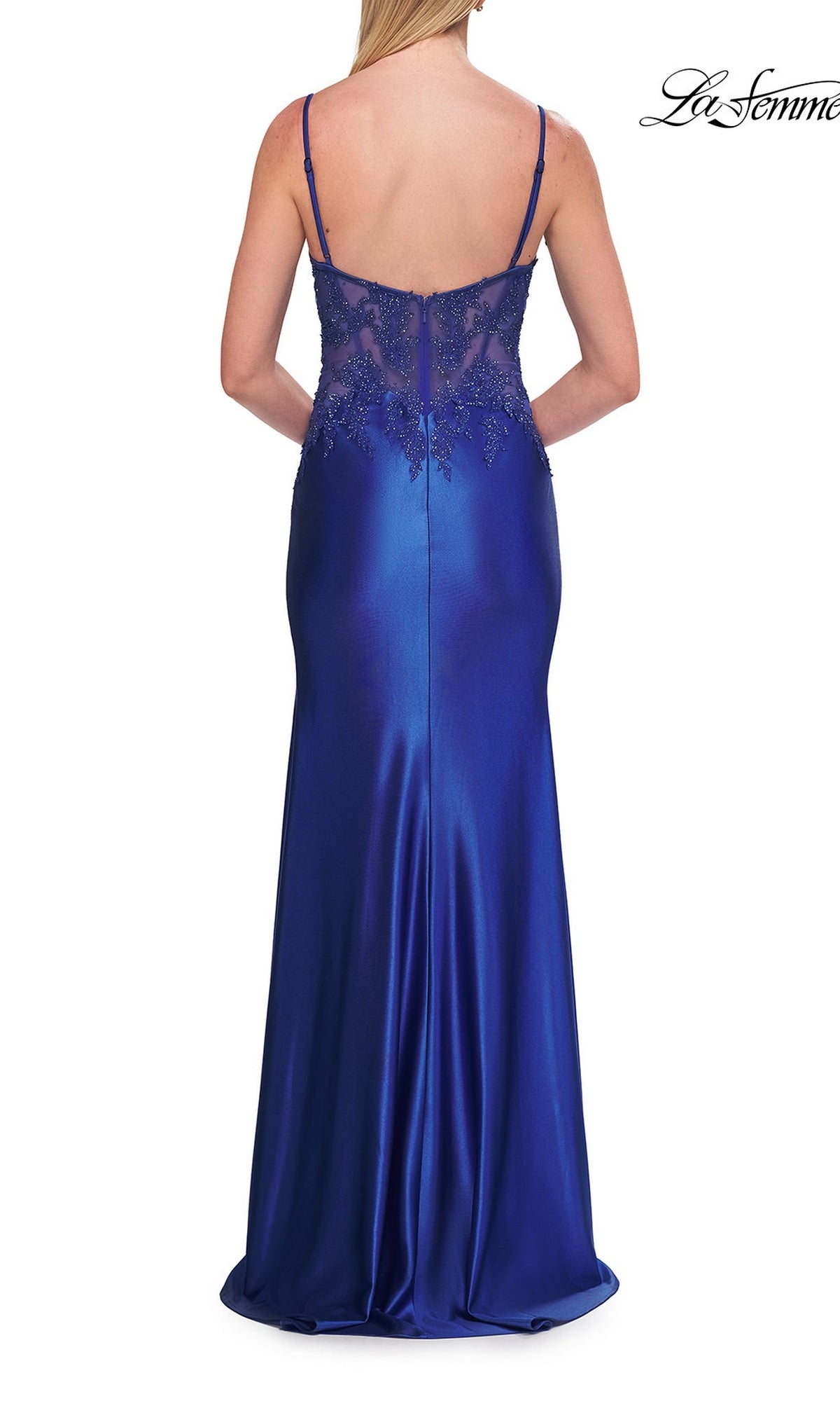Woman wearing the La Femme 33627 beaded-corset long prom dress, featuring a sleeveless, floor-length royal blue design with lace detailing on the back, standing with her back to the camera.