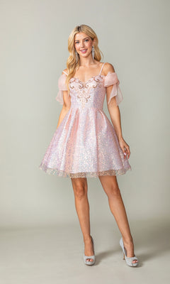 A woman models the Shoulder-Bow Short Glitter Homecoming Dress 3363 with sheer off-the-shoulder sleeves, corset lace-up back, and silver heels, posed against a plain light background.