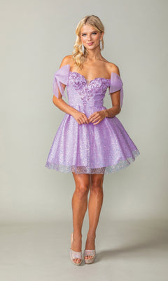A woman models the Shoulder-Bow Short Glitter Homecoming Dress 3363—a sparkly light purple dress with decorative shoulder bows and a corset lace-up back—standing against a plain light background.