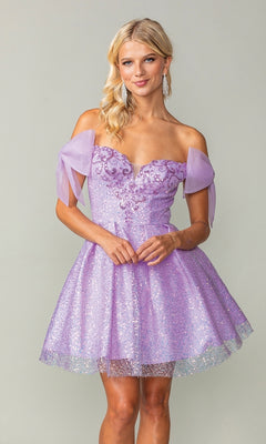 A woman models the Shoulder-Bow Short Glitter Homecoming Dress 3363, featuring off-the-shoulder tulle bows, sparkling sequins, and a corset lace-up back, as she stands against a plain background.