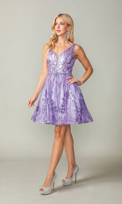 A woman stands against a plain light background wearing the Short Glitter-Print Hoco Dress: Dancing Queen 3364—a sleeveless, knee-length lilac semi-formal dress with floral embroidery—paired with silver high heels.