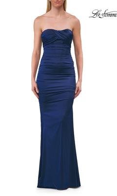 A woman wearing the Lace-Up Strapless Long Prom Dress La Femme 33654 in navy, standing against a white background.