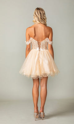 Woman wearing a champagne off-shoulder dress with lace details on a plain background