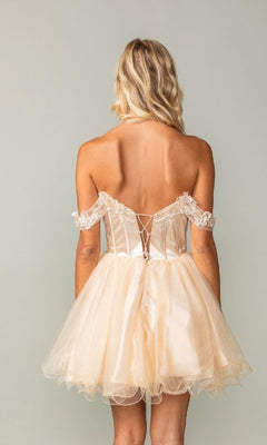 Woman wearing a champagne off-shoulder short dress with lace details on a plain background