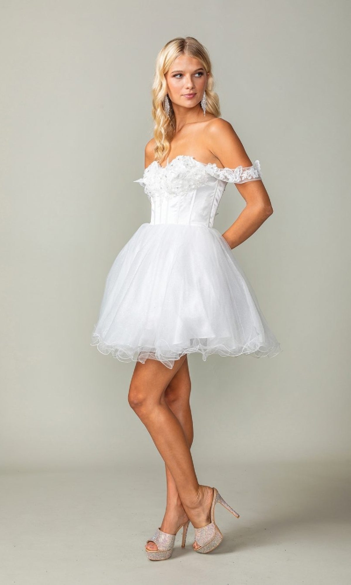 Woman wearing a white off-shoulder dress against a plain background