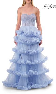 A woman wears the Strapless Tiered Prom Ball Gown: La Femme 33717 in light blue, showcasing a sweetheart neckline and a flowing ball gown silhouette with elegant tiered tulle ruffles. The structured upper bodice features sheer paneling, perfectly enhancing the romantic design. The brand name “La Femme 33717” is displayed in the top right corner.