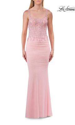 Woman wearing a sleeveless, baby pink La Femme 33721 open-back sheer-corset prom gown, featuring lace detailing on the bodice, beaded embroidery accents, a fitted silhouette, and straight neckline.