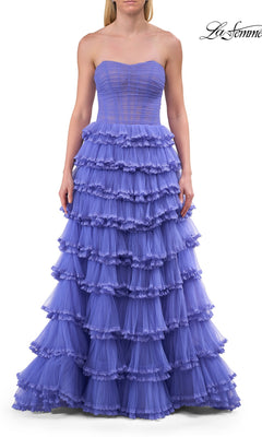A woman wears the Long Prom Dress: La Femme 33727, a strapless lavender tiered tulle ball gown with a fitted corset bodice and a full layered skirt. The background is white.