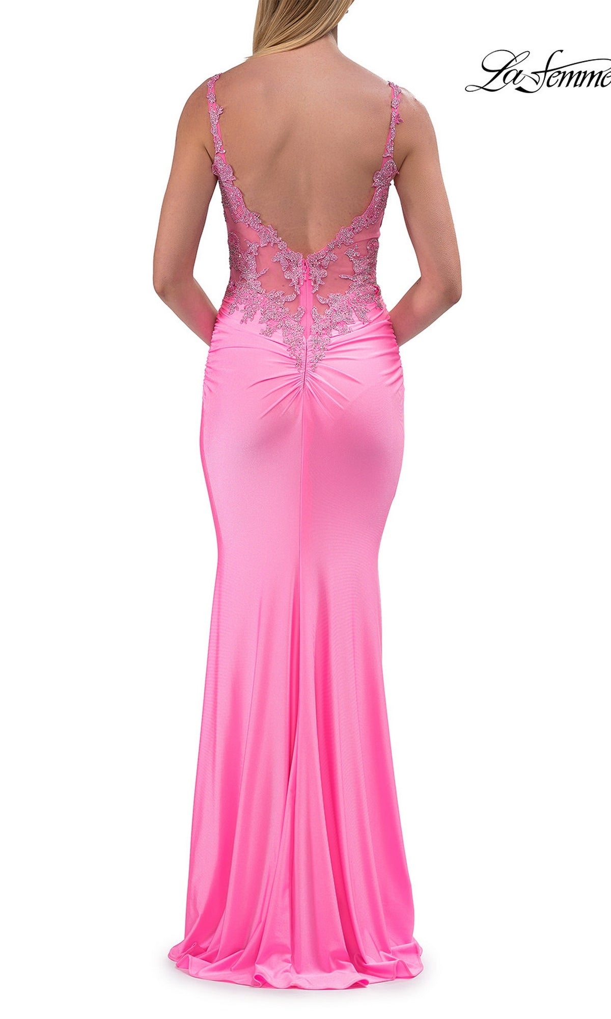 A woman stands with her arms behind her, wearing the La Femme 33731 Beaded-Bodice Long Prom Dress—a sleeveless, floor-length pink gown featuring an illusion-lace bodice and a low open back.