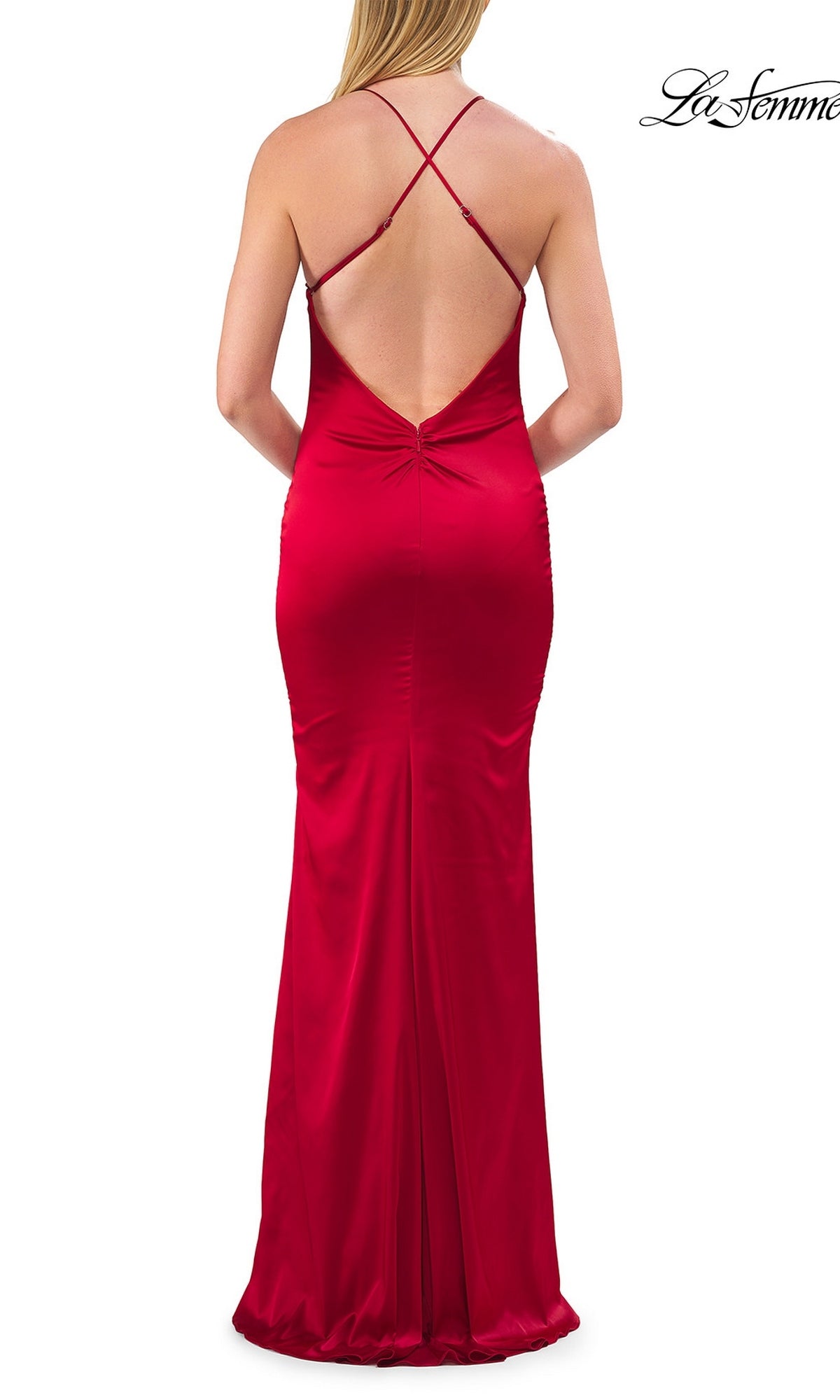 A woman is seen from behind wearing the Strappy-Back Long Satin Prom Dress: La Femme 33732, a floor-length red satin gown featuring crisscross straps and an open back—an elegant choice for prom or any formal occasion.