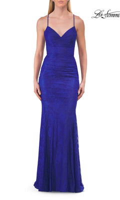 A woman wearing the Strappy-Back Classic Prom Gown by La Femme 33733 in royal blue—a sleeveless, floor-length gown featuring thin straps and a fitted silhouette—captures the elegance of a formal beaded gown.