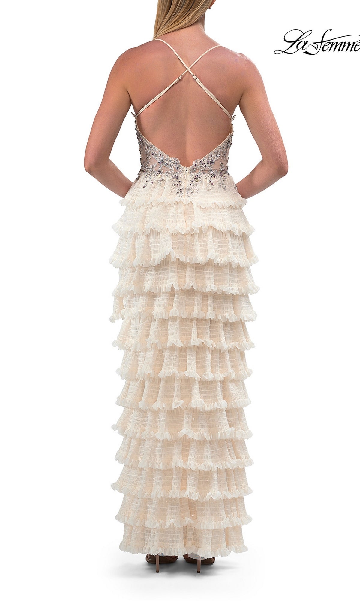 Woman in the La Femme 33751 Beaded-Corset Ruffle Prom Gown, featuring a sleeveless, crisscross-back cream design with tiered ruffles and a beaded sheer corset bodice, standing and facing away.