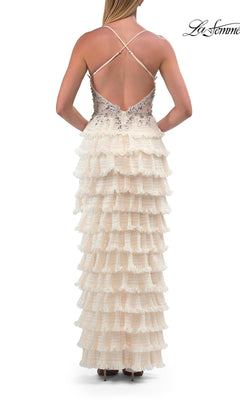 Woman in the La Femme 33751 Beaded-Corset Ruffle Prom Gown, featuring a sleeveless, crisscross-back cream design with tiered ruffles and a beaded sheer corset bodice, standing and facing away.