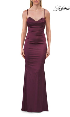 A woman wearing the La Femme 33764 Criss-Cross Open-Back Prom Gown in Dark Berry, a sleeveless, floor-length, fitted formal dress with thin straps, stands against a white background.
