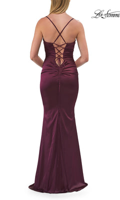 Woman in a sleeveless, floor-length, dark red satin Criss-Cross Open-Back Prom Gown by La Femme (style 33764), featuring lace-up back detail, viewed from behind.