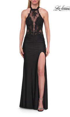 A woman wearing the Sheer-Corset High-Neck Prom Gown La Femme 33766 in black, featuring a sleeveless design with a lace bodice, sheer panel, high neckline, and thigh-high slit—an elegant prom dress beautifully complemented by silver heels.