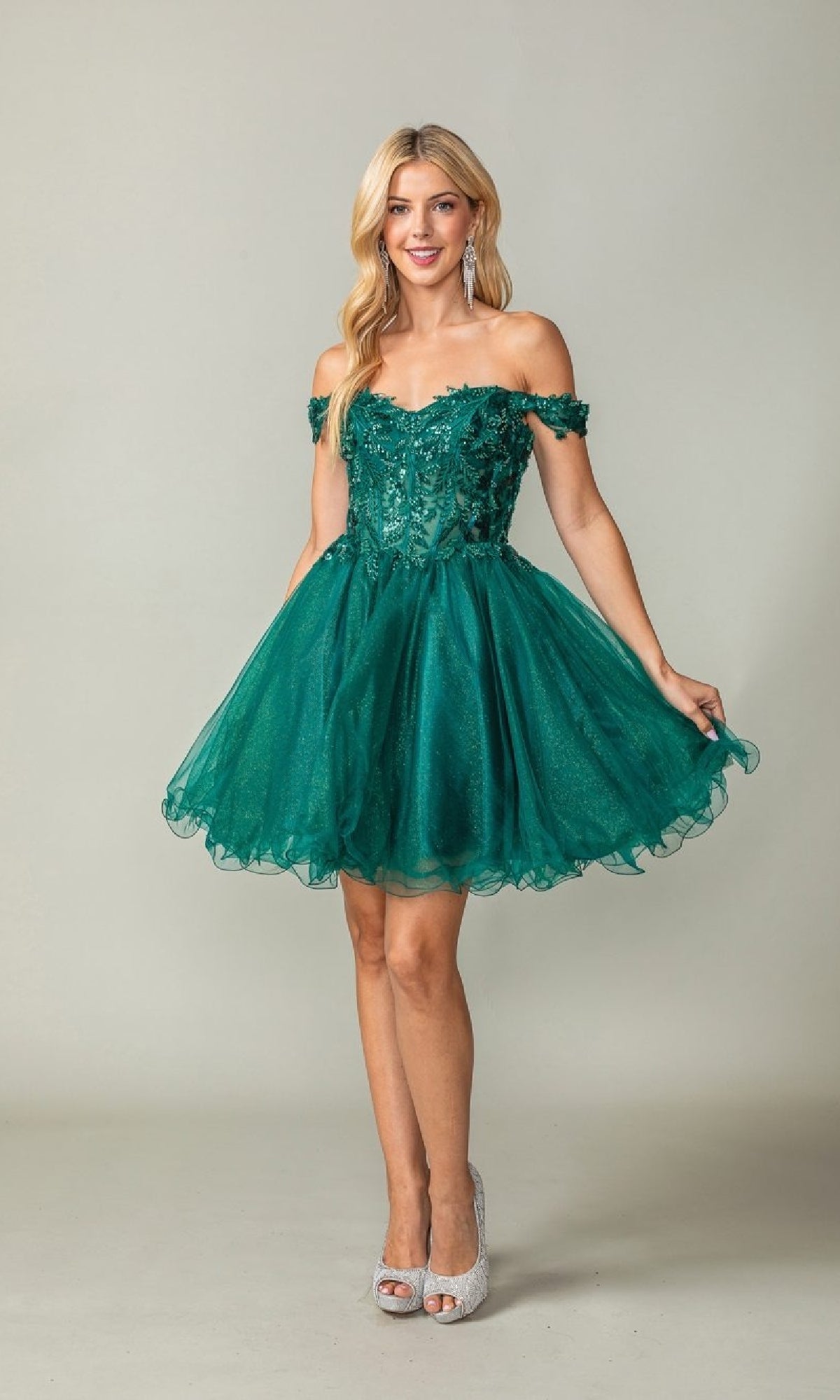 Woman wearing a green off-shoulder dress against a plain background