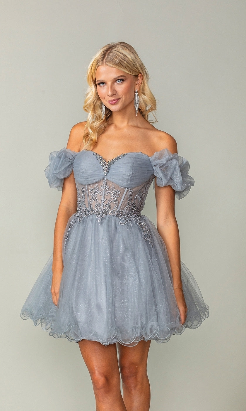 A woman stands against a plain background wearing the Ruffle-Sleeve Short Corset Homecoming Dress 3379, featuring light blue fabric, off-the-shoulder ruffle sleeves, lace detailing, and a fitted corset bodice.