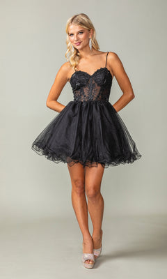 A woman wears the Sheer-Waist Short Babydoll Homecoming Dress 3382, a black dress with spaghetti straps, a tulle skirt, and corset-style bodice, paired with silver open-toe heels against a plain background.