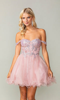 A woman models the Dancing Queen 3383, a short corset homecoming dress with off-the-shoulder sleeves, silver embroidery, a sparkly sheer bodice, and a tulle skirt, posing against a plain background.