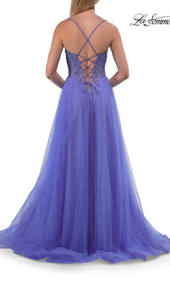 A woman seen from behind wearing the Sheer-Corset Long Prom Ball Gown: La Femme 33860, a sleeveless purple a-line dress featuring beaded details and a crisscross lace-up back.