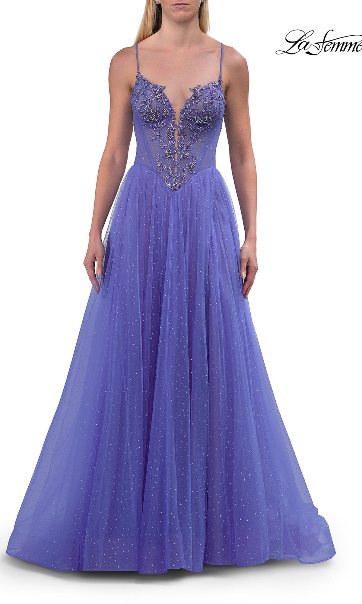 Dressed in the Sheer-Corset Long Prom Ball Gown: La Femme 33860, a woman showcases a floor-length, sleeveless purple gown adorned with floral applique and sparkling beaded accents. This elegant A-line prom dress features slender straps, a plunging V-neckline, and a sheer embroidered corset bodice that gracefully transitions into a voluminous tulle skirt.