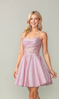 A woman wears the Cowl-Neck Short Glitter Homecoming Dress 3386, featuring floral lace bodice details, as she stands smiling against a plain background.