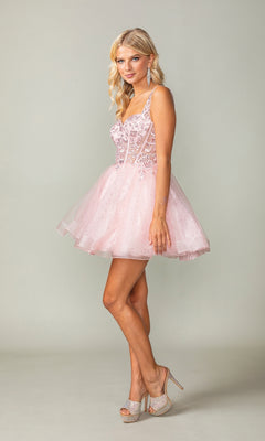 A woman is standing in profile wearing the Embroidered-Bodice Short Lace-Up Hoco Dress 3390, a short light pink glitter party dress with lace details and high-heeled shoes, set against a plain background.