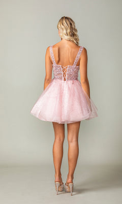 A woman faces away, wearing the Embroidered-Bodice Short Lace-Up Hoco Dress 3390 in light pink, featuring a lace-up back and tulle skirt, styled with high heels.