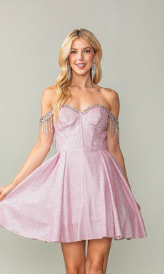 A woman models the Fringed Off-Shoulder Short Homecoming Dress 3392 in pink, featuring sparkling fabric, crystal fringe accents, and a flattering corset bodice against a plain background.