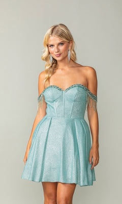 A woman in the Fringed Off-Shoulder Short Homecoming Dress 3392 with a corset bodice and beaded fringe stands against a plain background, her light blue glitter dress sparkling elegantly.