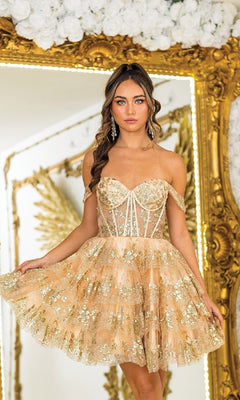 A woman in the Dancing Queen 3400 short ruffled Hoco dress stands before a large gilded mirror, framed by white flowers and golden angel wings in the background.