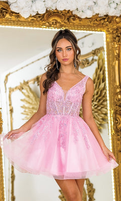A woman in the Dancing Queen 3414 Lace-Up Short A-Line Prom Dress stands before a large ornate mirror with gold-trimmed floral decorations.
