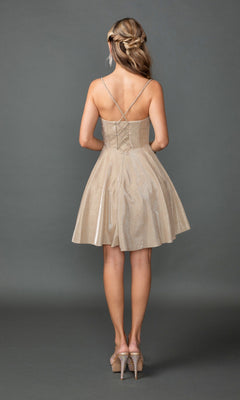 A woman faces away in the Dancing Queen 3421 short prom dress, featuring glitter fabric, crisscross straps, a lace-up back, and corset bodice detail with high heels, set against a plain gray background.
