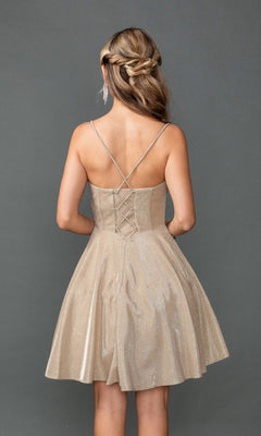 Woman modeling the Dancing Queen 3421 short prom dress in sparkly beige glitter with crisscross straps, a lace-up back, and corset bodice, stands against a plain gray background facing away from the camera.