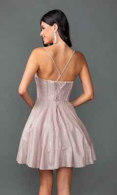 A woman wears the Dancing Queen 3421 short prom dress—sparkly light pink glitter, A-line skirt, sleeveless, with crisscross straps and a lace-up back—standing against a plain gray background.