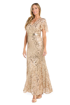 A woman wearing the R&M Richards 3425 Long Gold Sequin Formal Dress with short flutter sleeves and a V-neckline stands and smiles.