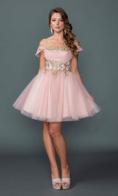 Wearing the Dancing Queen 3433 short homecoming dress in blush, the woman stands against a plain gray background, holding the sides of her pink glitter tulle skirt. The off-the-shoulder dress features a beautifully embroidered corset bodice.