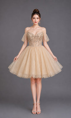 A woman poses against a gray backdrop wearing the Dancing Queen 3438 short homecoming dress in champagne, featuring off-the-shoulder straps, a beaded bodice, and a sparkly tulle skirt, paired with silver heels.